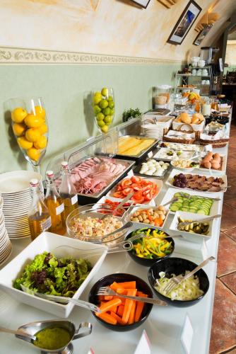 a buffet line with many different types of food at Hotel Regent in Kraków