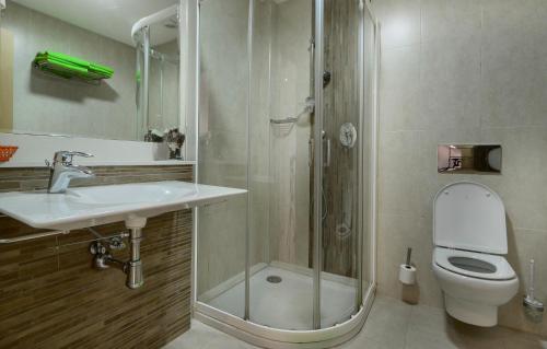 a bathroom with a shower and a sink and a toilet at Apartamentos Benitachell in Benitachell