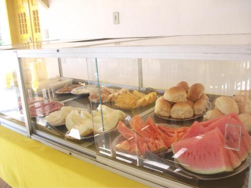 a display case filled with lots of different types of food at Pousada Hawai in Conde