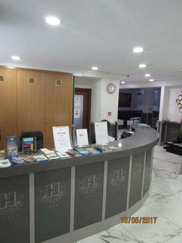 a lobby with a counter with books on it at Hotel Excelsior in Lisbon