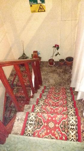 a room with a table and a rug on the floor at Hostal El Toque de Pilar in Punta Arenas