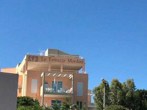 a building with a sign that reads lle traversemont at Le Terrazze Mordini in La Maddalena