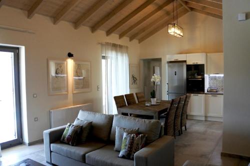 a living room with a couch and a table at Euphoria Retreat in Mánganos