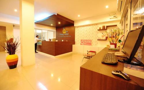 a lobby with a counter with a computer and a cash register at S2S Queen Trang Hotel in Trang