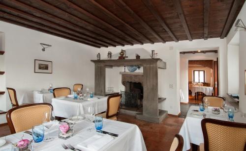 a dining room with two tables and a fireplace at Vecchia Osteria Seseglio in Chiasso