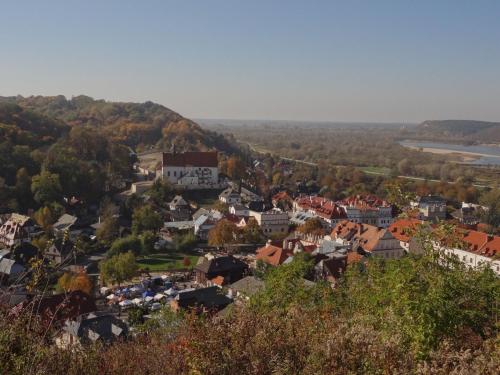 a small town on a hill with a river at Pensjonat Pod Wietrzną Górą in Kazimierz Dolny