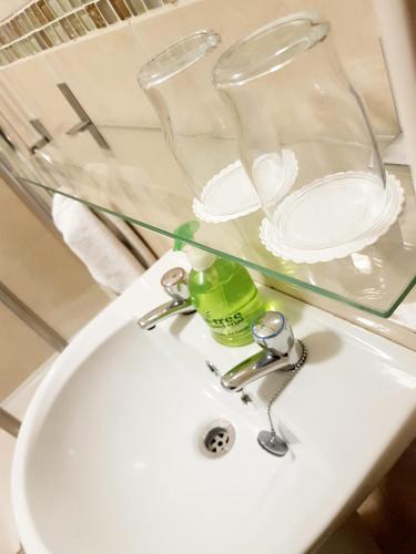 a bathroom sink with a glass shelf above it at Belfast House in Cookstown