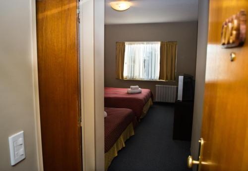 Ένα ή περισσότερα κρεβάτια σε δωμάτιο στο Marcopolo Suites Calafate