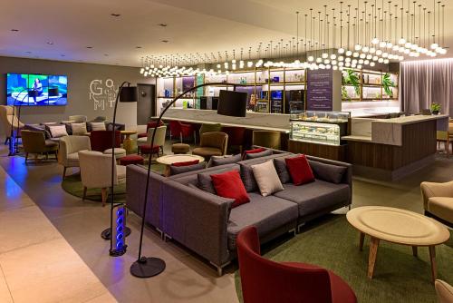 a waiting room with couches and chairs in a store at Novotel Sao Paulo Center Norte in Sao Paulo