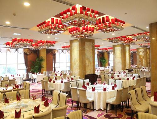 a banquet hall with tables and chairs and chandeliers at Ramada Chengdu North in Chengdu