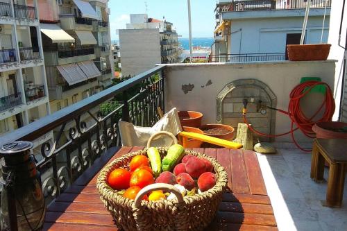a basket of fruit on a table on a balcony at Private Room In a Shared Flat in Thessaloniki