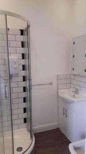 a bathroom with a shower and a sink at Stafford apartments in Stafford