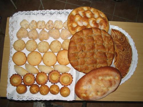 a tray of pies and breads on a table at Casa Rural Garrido in Ademuz