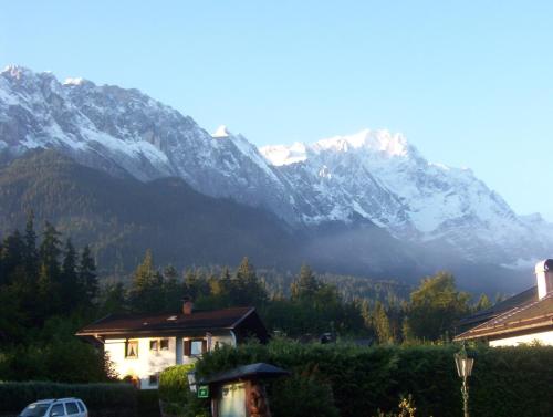 a view of a mountain range with a house at Gasthaus am Zierwald in Grainau