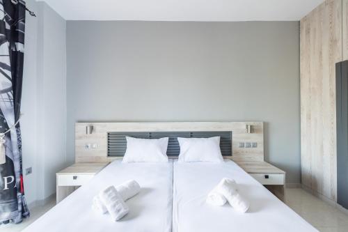 a bedroom with a white bed with two white pillows at Maritina Apartments in Ixia