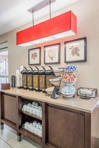 a counter with plates and bowls on it at Country Inn & Suites by Radisson, Cookeville, TN in Cookeville