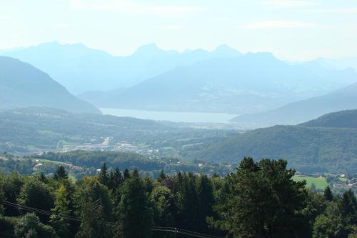 a view of a valley with trees and mountains at The Originals City, Hôtel Rey du Mont Sion, Saint-Julien-en-Genevois Sud in Saint-Blaise