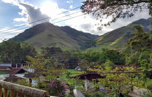 a mountain in the distance with houses and trees at Albergue Muzy in Sana