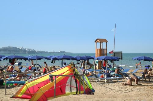 a group of people on a beach with a kite at Hotel Portonuovo in Vieste