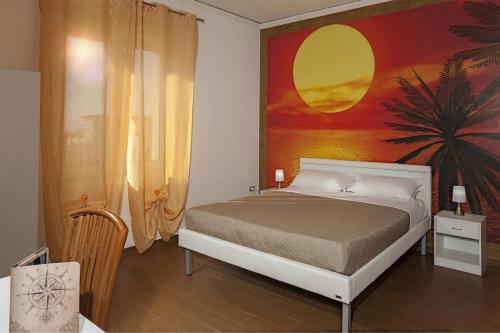 a bedroom with a bed with a painting on the wall at Enjoy Vida in Casola di Napoli