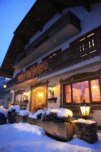 a house with snow on the ground in front of it at Gasthof Karlwirt in Sankt Andrä im Lungau
