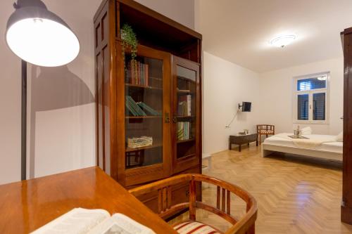 a dining room with a table and a room with a bed at Villa Dubravka - heated outdoor pool and indoor jacuzzi in Zaton
