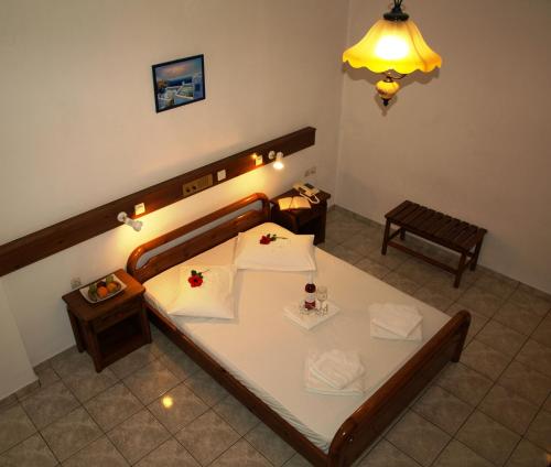 a hotel room with a table and a lamp at Levante Beach Hotel in Kamari