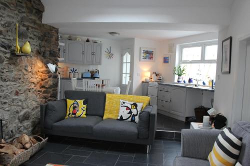 a living room with a couch and a kitchen at Cara-Na-Mara in Killough