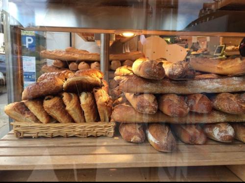 a display case in a bakery filled with lots of bread at Cosy Apartment near Eiffel Tour in Paris
