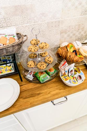 a buffet with cookies and other food on a table at Maison degli Artisti in Ravenna