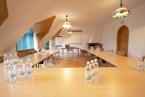 a large room with a long table with wine bottles on it at Geovita Muszyna in Muszyna