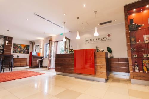 a store with a red counter in a room at HOTEL KOCKS am Mühlenberg in Mülheim an der Ruhr