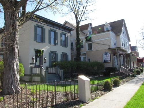 a house with a fence in front of it at Historic LaSalle Downtown in Fort Wayne
