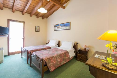 Postel nebo postele na pokoji v ubytování Hotel Conca Verde