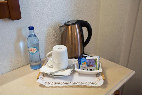 a table with a cup of coffee and a bottle on it at Hotel Solaris in Setúbal