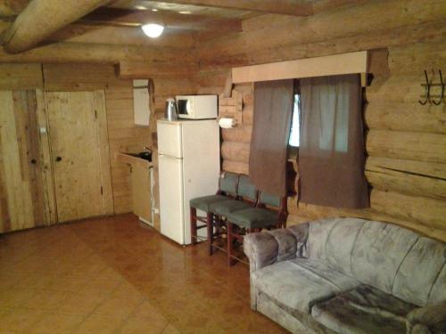 a living room with a couch and a refrigerator at Huntingbox in Purila