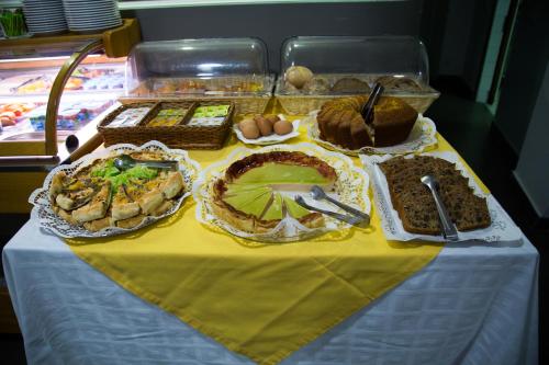 a table with many different types of food on it at Hotel Solaris in Setúbal