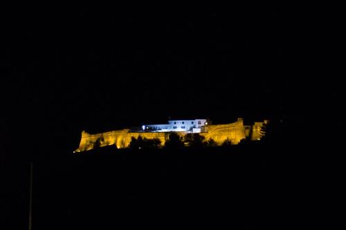a building on top of a castle at night at Hotel Solaris in Setúbal