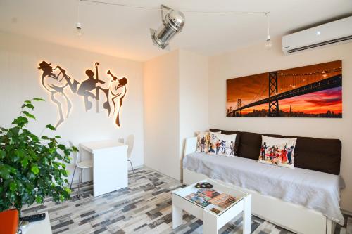 
a living room filled with furniture and a painting at Jazzy Sofia Downtown Apartment in Sofia
