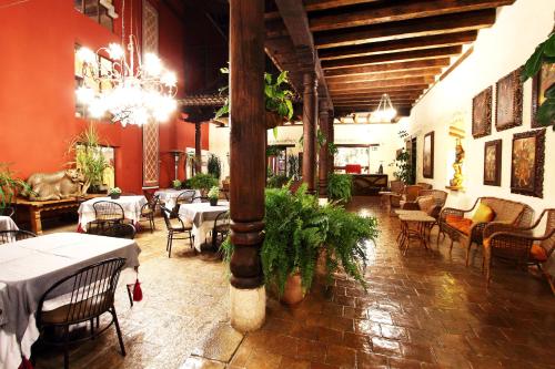 a restaurant with tables and chairs and a chandelier at Mision Grand San Cristobal de las Casas in San Cristóbal de Las Casas