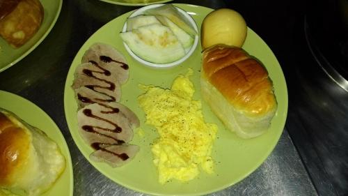 a plate of breakfast foods with eggs and croissants at Beetles Forest in Jiaoxi