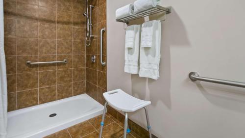 a bathroom with a shower and a toilet and a sink at Best Western Plus Chateau Inn Sylvan Lake in Sylvan Lake