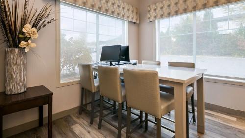 a dining room with a table with chairs and a computer at Best Western Mountainview Inn in Golden