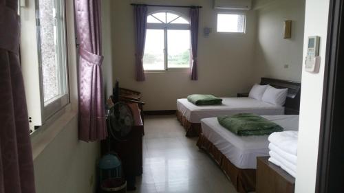 a room with two beds and a window at A-Ma Homestay in Fengli