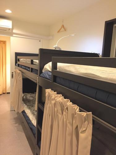 two bunk beds in a room with towels hanging from them at Tokyo Art House in Tokyo