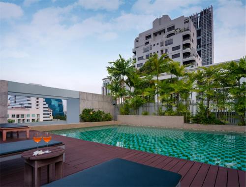 a swimming pool on the roof of a building at Silom Lofts in Bangkok