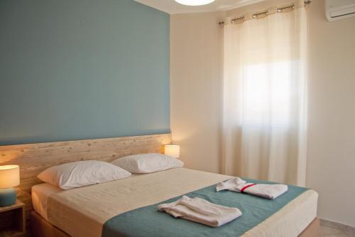 a bedroom with a bed with two towels on it at Alkyonida Apartments in Chania Town