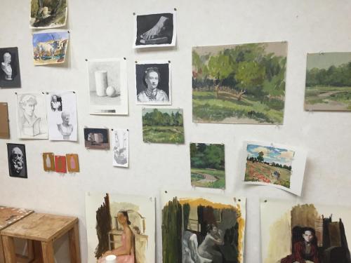 a wall with paintings and drawings on it at Tokyo Art House in Tokyo