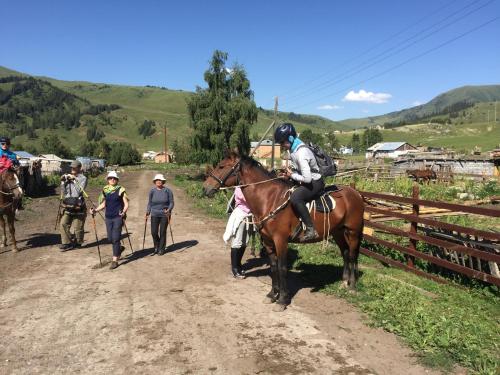 a man riding a horse on a dirt road at Alakol-Jyrgalan Guest House in Dzhergalan