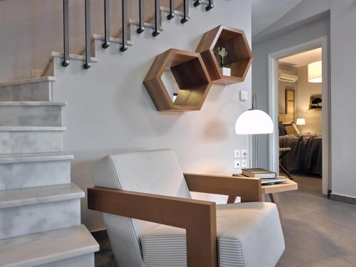 a living room with a table and a chair and stairs at Cielo villas - An Authentic Mediterranean Living in Zakynthos Town